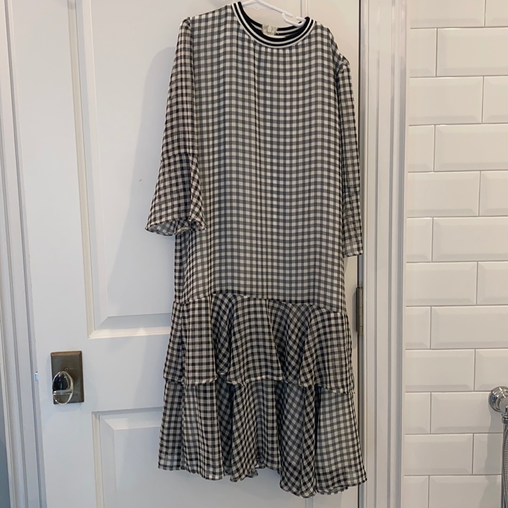 Black and white checkered dress. Sheer sleeves. Two ruffles at the bottom.